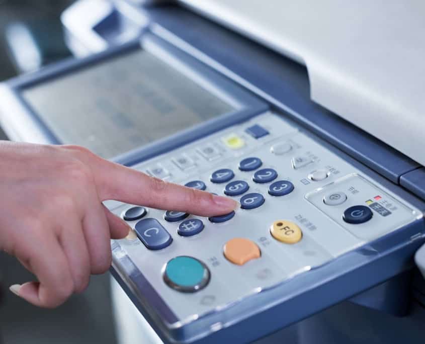 Close up of person using a copier