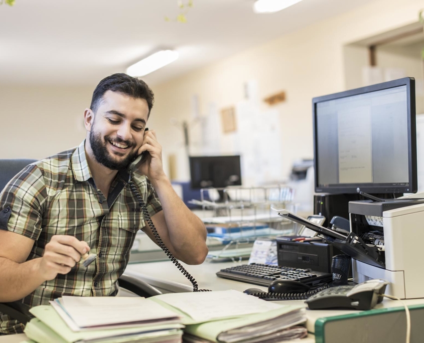 Front view of office worker talking on phone