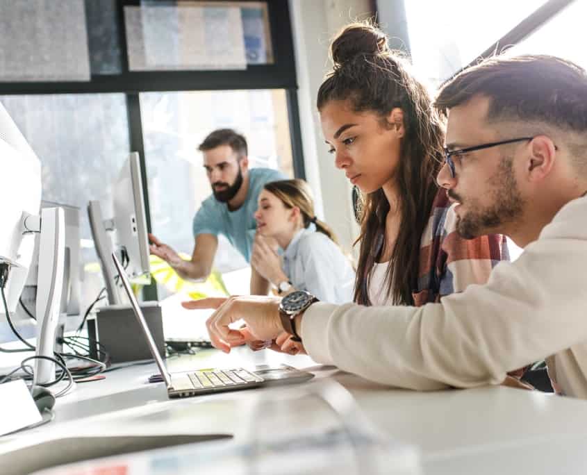 Side view of office workers on computers