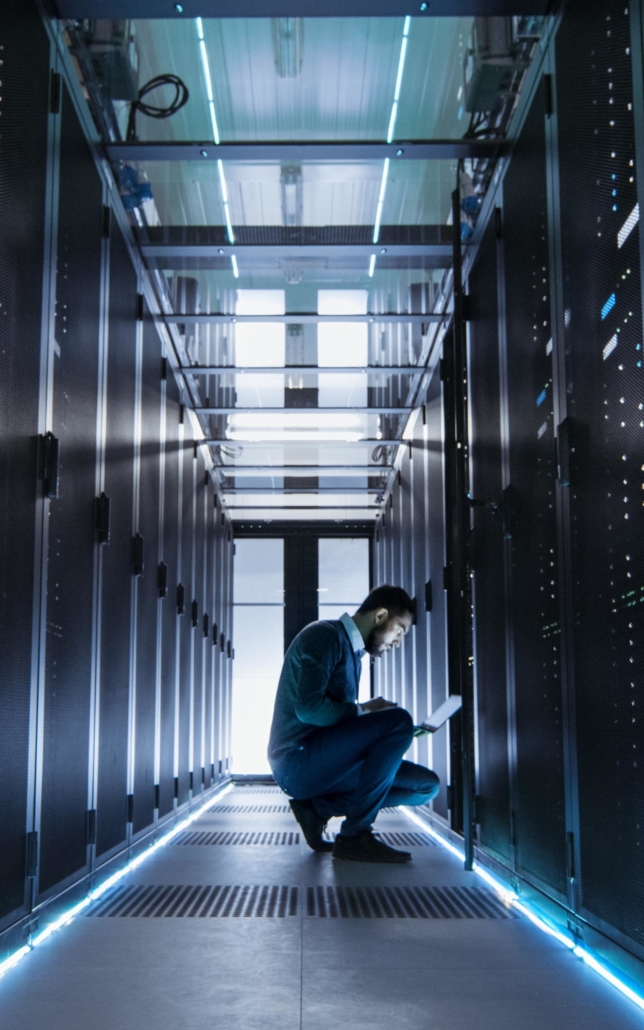 Tech worker using laptop to check server status