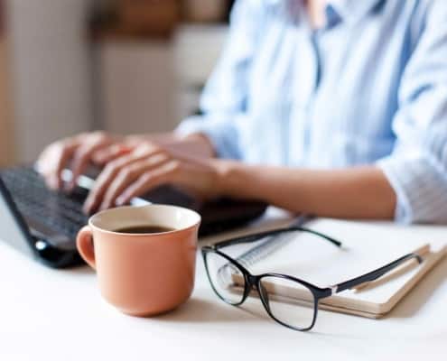 close up of woman working on a laptop