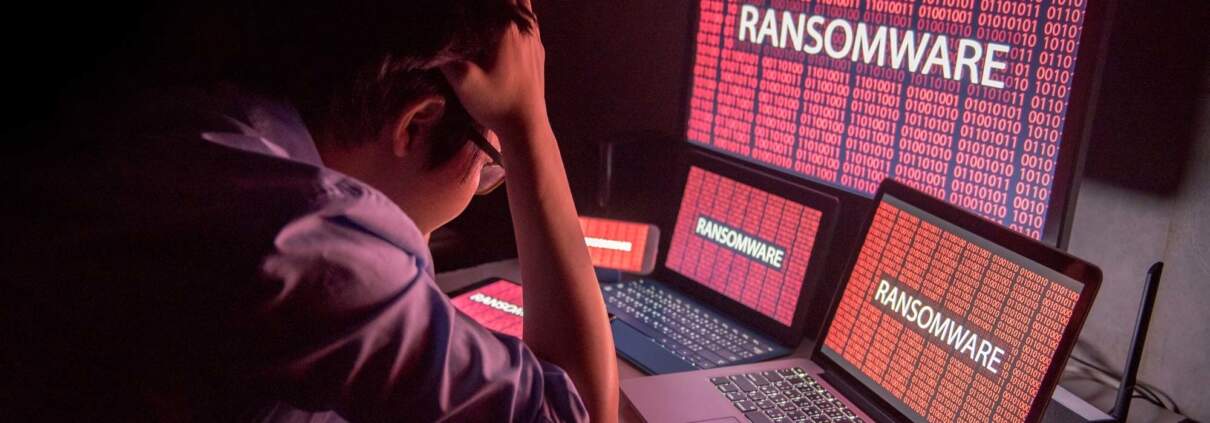 man suffering from a ransomware attack on computers