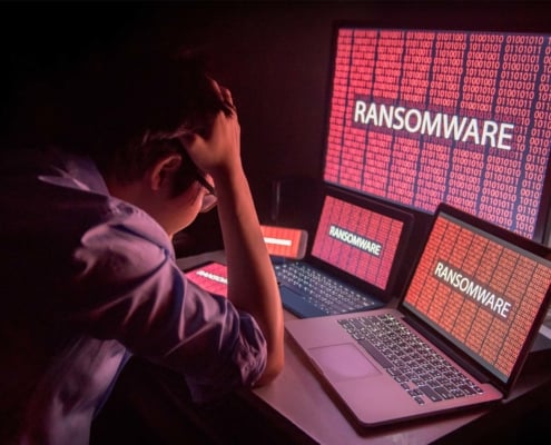 man suffering from a ransomware attack on computers