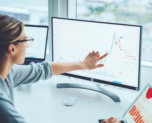 woman working on a computer looking at a chart