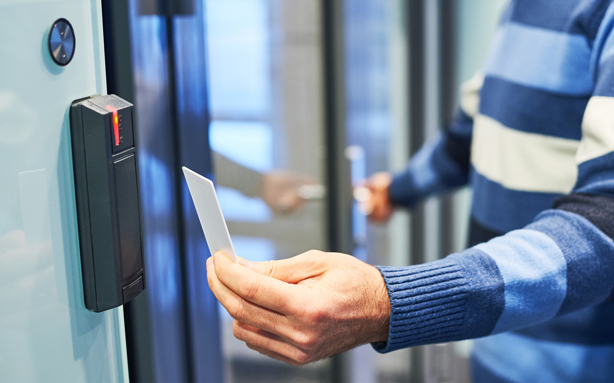 Side view of a man swiping access control card