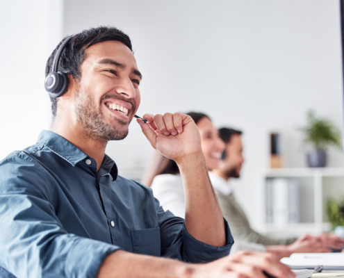 Business, pc and man with telemarketing, help desk and customer service in modern office