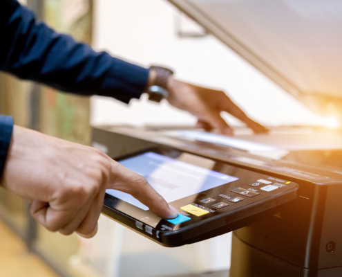 Business man Hand press button on panel of printer