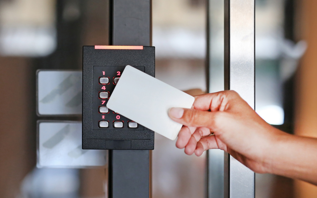Close Up Of Hands Using Id Card To Get Into Building