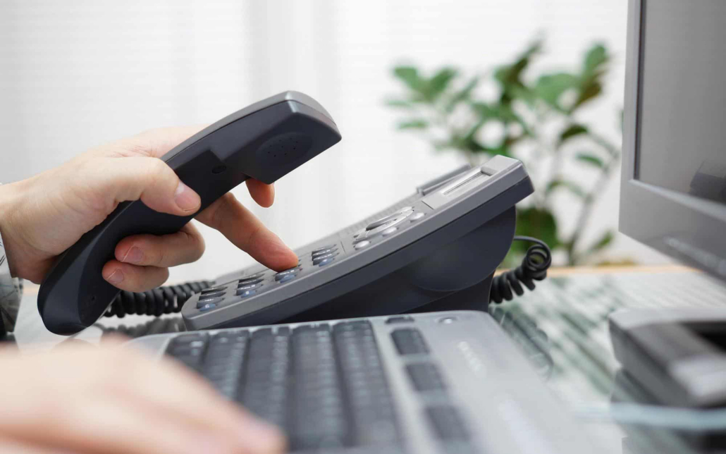 Close Up View Of Office Worker Dialing Phone