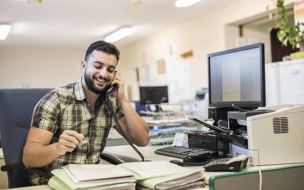 Front View Of Office Worker Talking On Phone