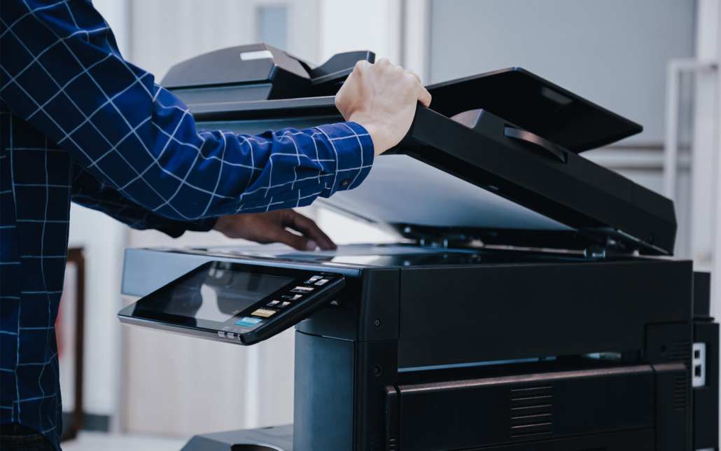 Hands Of A Person Using Copy Machine