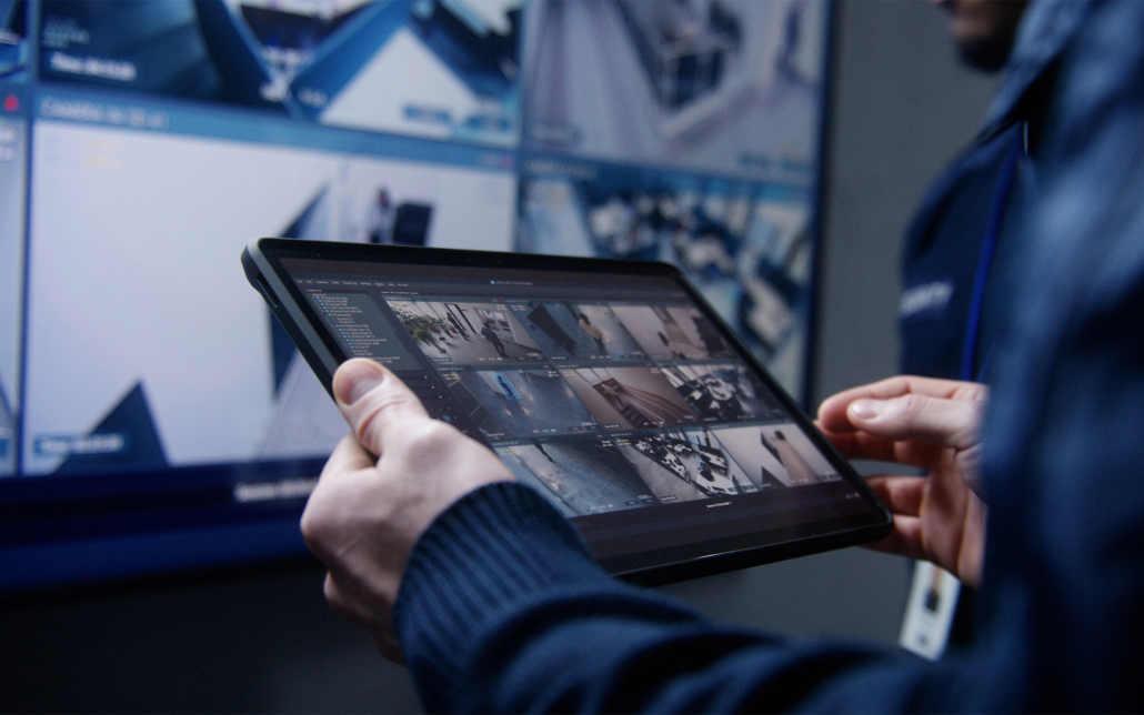Hands Of A Security Guard Holding A Tablet With View Of Cct Cameras
