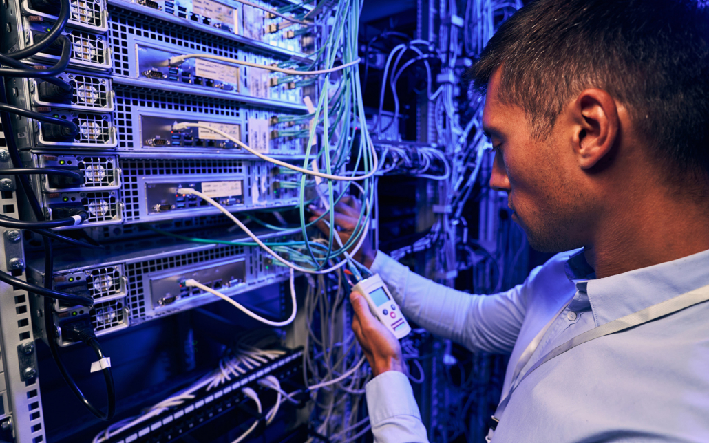 Man Performing Test In Server Room