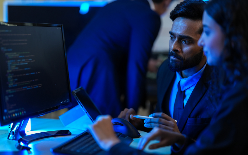 People Sitting At A Desk Monitoring Data