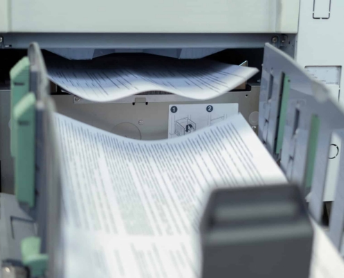 Front View Of A Document Being Printed Out On Commercial Printer